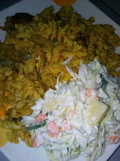 A picture of Macaroni jollof with fish and potato salad.