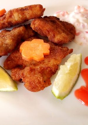 A picture of Grilled fish marinade in tartar sauce.
