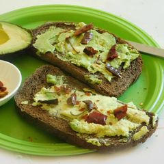 A picture of Open face sandwich with Rye Bread, and Avocado.