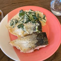 A picture of Pan fried salmon with white cream sauce.