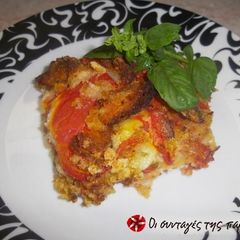 A picture of Tomatoes on the plate or Tomatoes with breadcrumbs.