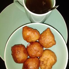 A picture of Puff puff with black tea.
