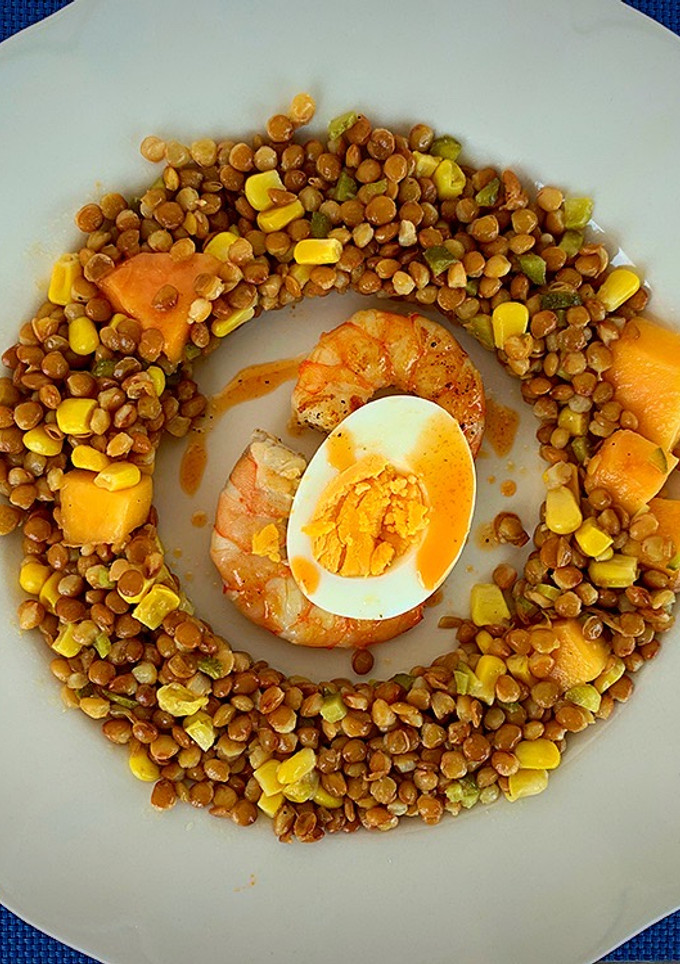 Una foto de Ensalada de lentejas, papaya, huevo, langostinos y el aliño de sus cabezas
