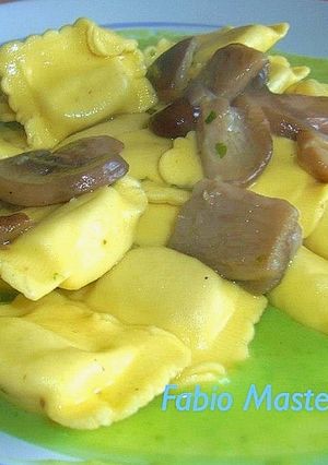 A picture of Ravioli Stuffed with Ground Meat, with Sautéed Cremini Mushrooms on Pea Purée.