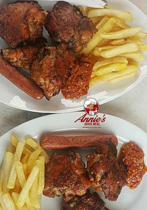 A picture of Bbq Turkey,sausage and Chips with pepper sauce.