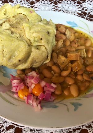 Una foto de Juane de arroz acompañando con su frejolito melamela y salsa de cebolla con ají charapita