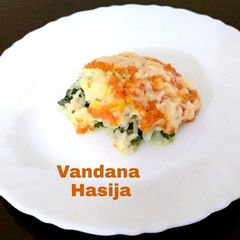 A picture of Layered Corn,Spinach Rice With Tomato Sauce.