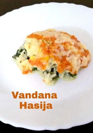 A picture of Layered Corn,Spinach Rice With Tomato Sauce.