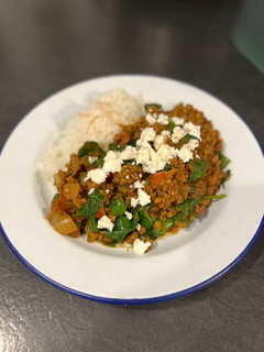 A picture of Persian beef and lentils topped with feta.