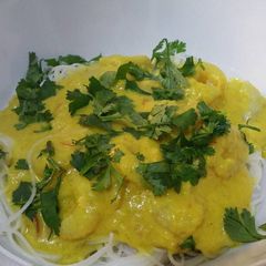 A picture of Sweet and spicy prawn and coconut curry with rice noodles.