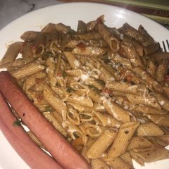 A picture of Penne in hot tomato and herb sauce.