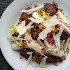 A picture of Bitter leaf salad with charred dates and vinaigrette.