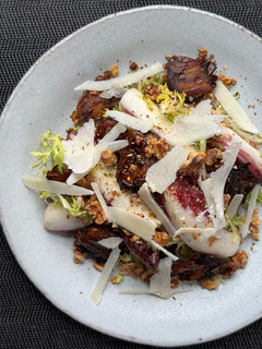 A picture of Bitter leaf salad with charred dates and vinaigrette.