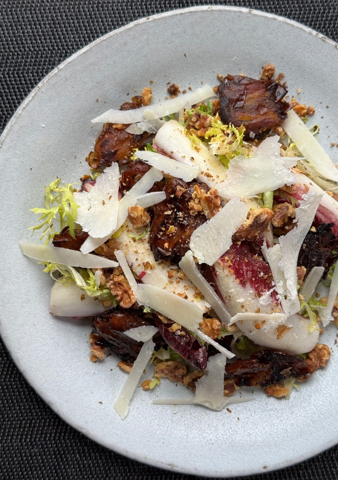 A picture of Bitter leaf salad with charred dates and vinaigrette.