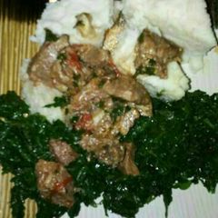 A picture of Ugali served with managu & beef.