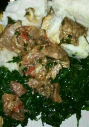 A picture of Ugali served with managu & beef.