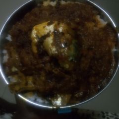 A picture of White rice with palm oil stew.