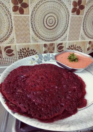 A picture of Beet root chila with spicy chutney.