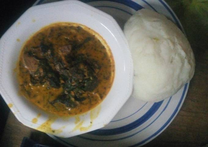 Bitter leaf soup served with poundo yam