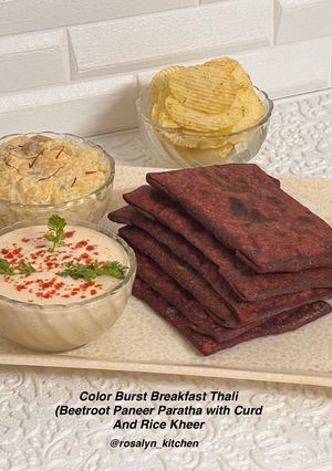 A picture of Color Burst Breakfast (Beetroot Paneer Paratha with Curd, Rice Kheer & Chips).