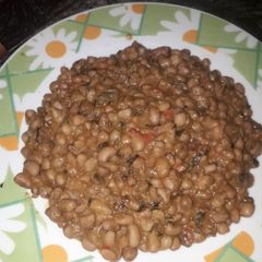 A picture of Jollof beans with scent leaf.