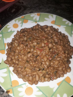 A picture of Jollof beans with scent leaf.