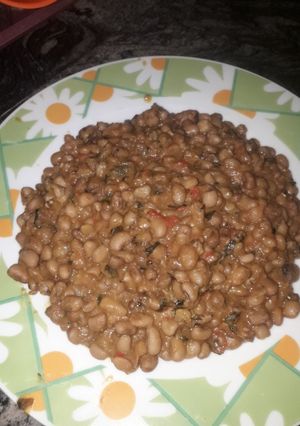 A picture of Jollof beans with scent leaf.
