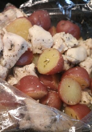 A picture of Succulent butter roasted chicken and potatoes in a bag.
