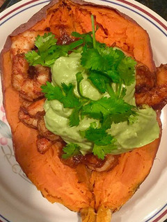 A picture of Spicy Shrimp Sweet Potato Boat and Avocado Crema.