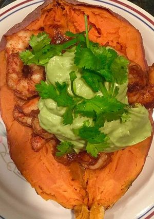 A picture of Spicy Shrimp Sweet Potato Boat and Avocado Crema.
