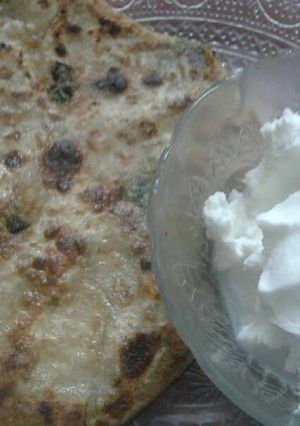 A picture of Methi aalu paratha with homemade white butter.