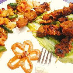 A picture of Spicy Honey-Yogurt Mutton Kababs with sautéed veggies.