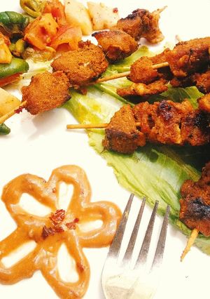 A picture of Spicy Honey-Yogurt Mutton Kababs with sautéed veggies.