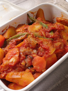 A picture of Braised Pork belly and sweet potato with tomato.
