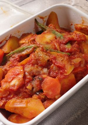 A picture of Braised Pork belly and sweet potato with tomato.