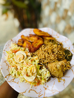 A picture of Mandi rice with coleslaw and plantain.
