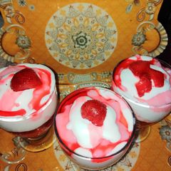 A picture of Strawberry dessert with whipped cream.
