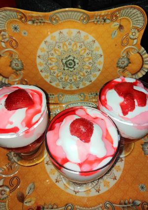 A picture of Strawberry dessert with whipped cream.