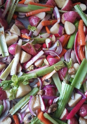A picture of Roasted red potatoes, red raddishes, red onion, & carrots, leeks.