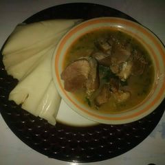 A picture of Agidi with goatmeat peppersoup.