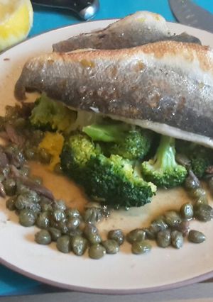 A picture of Pan fried seabass fillets on a bed of citrus broccoli.