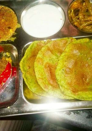A picture of Bathu palak puri with curd.