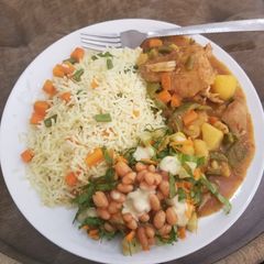 A picture of Chinese rice with chicken curry soup.