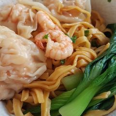 A picture of Carrot Noodle With Shrimp Dumplings.