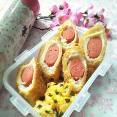 A picture of Lunch Box Menu: Sausage Rolled with Bread + Scrambled Egg.