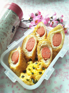 A picture of Lunch Box Menu: Sausage Rolled with Bread + Scrambled Egg.