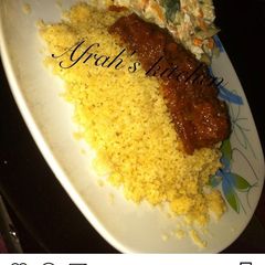 A picture of Steamed cous cous with stew.