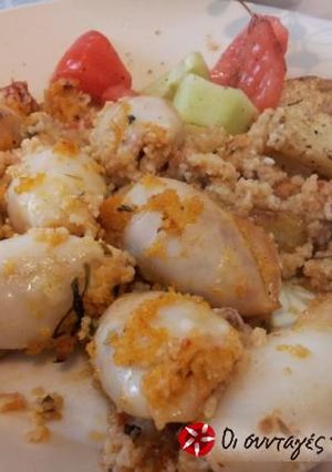 A picture of Calamari stuffed with cracked wheat and vegetables.