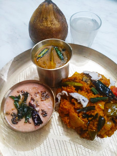 A picture of Vegetables Matta Rice with Thakkali Pachadi and Sambhar.