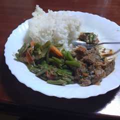 A picture of Beef Stew with Sautéed Vegetables and Rice.
